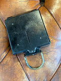 Compass shown closed from a different angle, showing overall case condition