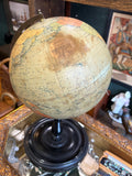 Philip's 9 inch globe showing the North Pacific and maker's cartouche, with staining around the label visible