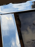 Detail of chrome frame corner and nibble to the edge of the glass of the vintage coffee table