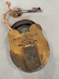Vintage Rahmatulla & Co brass padlock with key and cord on white background