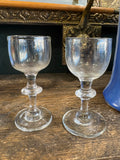 18th-century Georgian hand-blown port glasses on a wooden surface