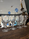 Set of four Georgian cordial glasses grouped together showing engraved pattern