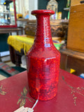Manfred Buchholz red pottery vase displayed on antique shop table