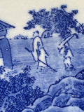 Detail showing figures in landscape scene on Japanese blue and white ceramic plate