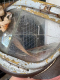 Close-up of cracked glass lens on vintage WWII-era RAF pattern flying goggles