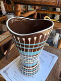Top view of vase opening showing brown glazed interior and wavy rim