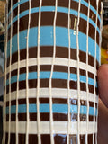 Close-up detail of brown, blue and white striped drip glaze pattern