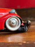 Close-up of front side of Schuco vintage red toy car 