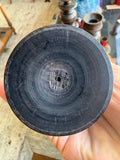 Base of a candle cup showing turning marks and wear