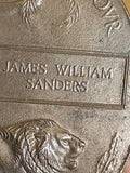 Close-up of James William Sanders name plate on memorial plaque