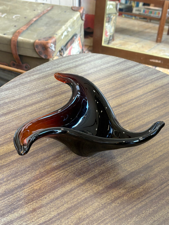 Vintage 1960s Murano freeform amber glass bowl on display table.