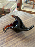 Vintage 1960s Murano freeform amber glass bowl on display table.