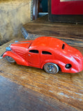 Left side profile of red Schuco Patent clockwork toy car