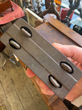 Underside of GTP 552 tinplate coach held in hand showing pressed metal base plate with oval cut-out openings typical of GTP construction