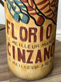 Close-up of "Florio Cinzano, Le Meilleur Marsala, Le Meilleur Aperitif" lettering in raised relief on ceramic bottle.