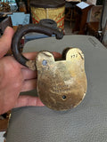 Reverse of padlock held in hand showing Aligarh Rs42/50 and 777 stamps