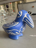 Side view of cobalt blue pottery bird with incised leaf patterns
