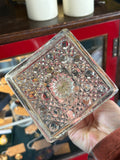 Base detail of antique pressed glass candlestick