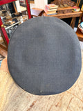 Top view of the crown of an RAF airman's peaked cap in blue-grey wool, with light marks near the rear edge