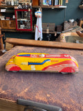 Side profile of vintage 1950s JBP Products tinplate streamlined racing car number 5 on display surface