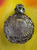 Reverse side of vintage Czech amethyst perfume bottle showing plain oval glass panel within filigree surround