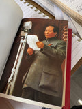 Colour photographic plate of Mao Tse-Tung reading a speech at a microphone inside the "Little Red Book."
