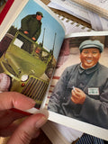 Two colour photographic plates of Mao Tse-Tung, one on a military vehicle, one smiling in a cap, inside the book.