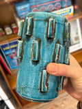 Hand holding a turquoise crackle glaze vase showing the raised blocks and glossy glaze