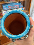 View into a turquoise vase showing the glazed rolled rim and unglazed terracotta interior