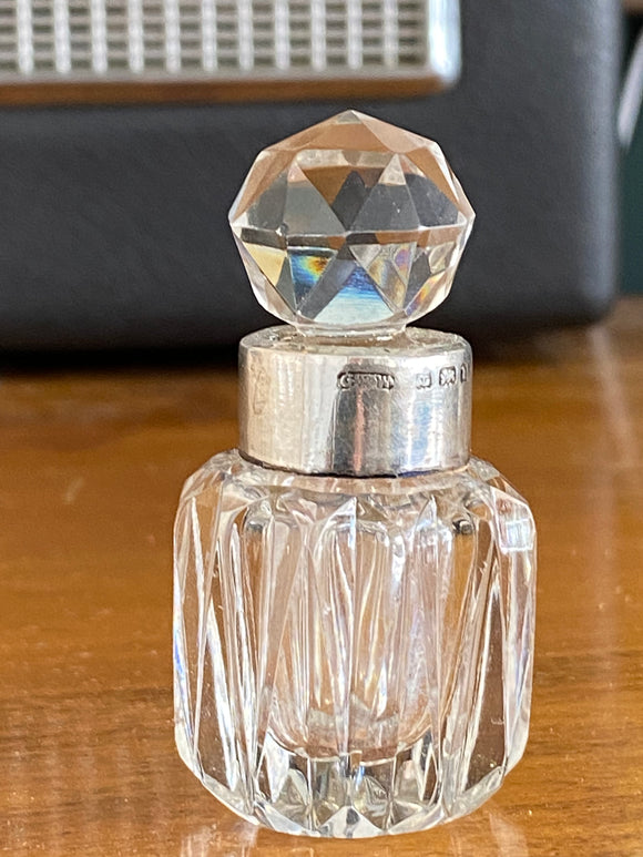 Small Victorian cut glass perfume bottle with silver banded neck